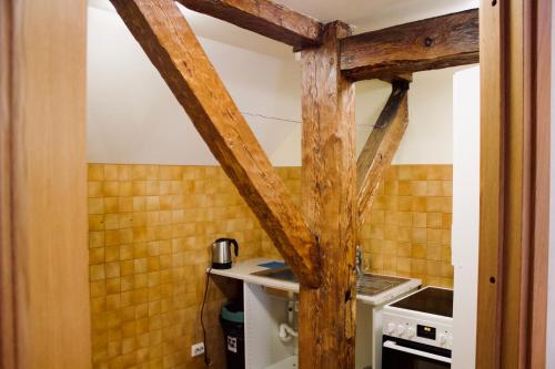 a kitchen with a wooden beam in a room at Skyview Hostel in Tallinn