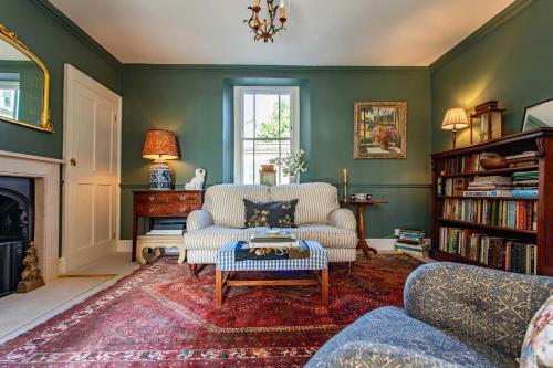 a living room with a couch and a table at Grand Georgian Residence in Bath
