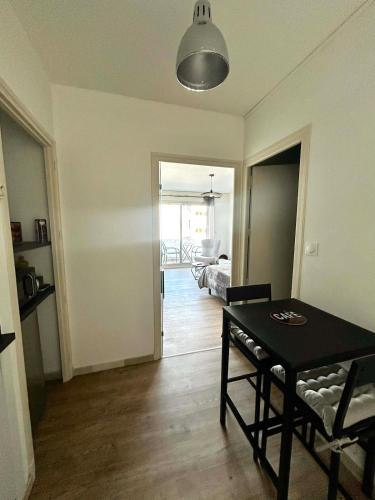 a living room with a table and a dining room at Appartement carmes in Aurillac