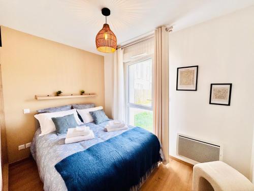a bedroom with a blue bed and a window at L'Orée des Pins - Suite parentale - Merlimont in Merlimont