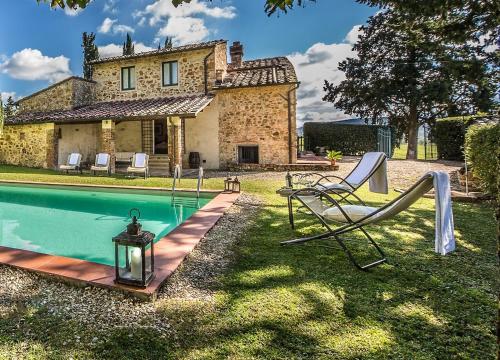 a house with a swimming pool in front of a house at Riant Relais de Charme in Greve in Chianti
