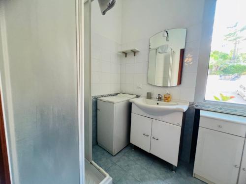 a white bathroom with a sink and a mirror at Suite Semeria 44 - Sanremo in Sanremo