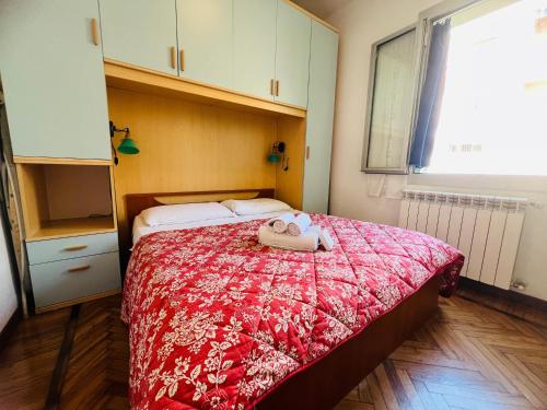 a bedroom with a bed with a stuffed animal on it at Suite Semeria 44 - Sanremo in Sanremo