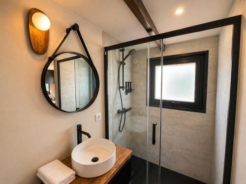 a bathroom with a shower with a sink and a mirror at Tiny Escape in São Miguel do Mato