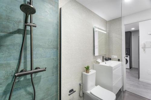 a bathroom with a shower and a toilet and a sink at Olivia’s Beach in Candelaria