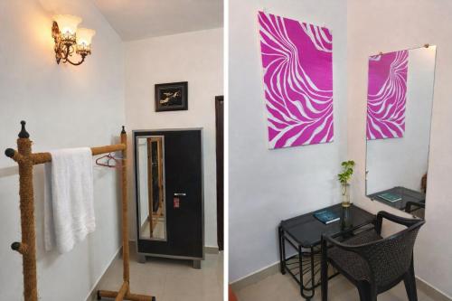 a room with a table and a mirror at Coconut Inn - Parra Goa in Mapusa