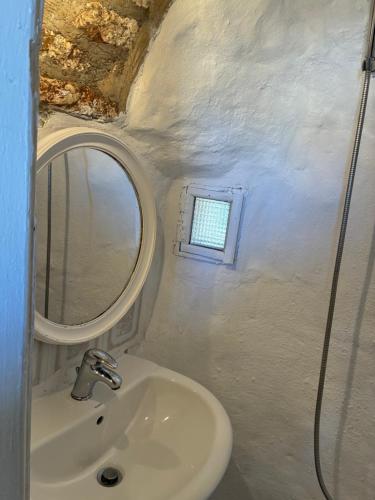 a bathroom with a sink and a mirror at The Windmill in Symi