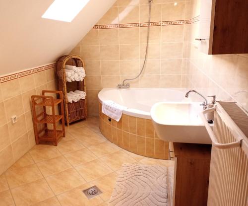 a bathroom with a sink and a bath tub at Apartment Rozika in Slovenj Gradec