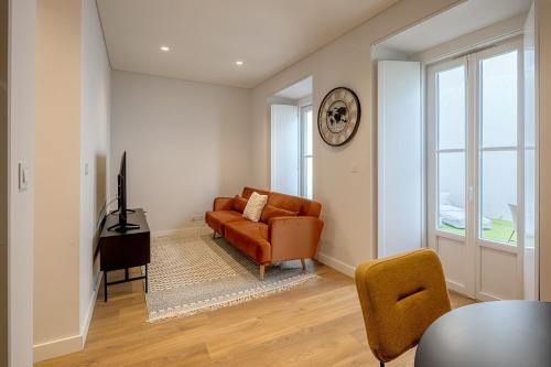a living room with a couch and a chair at Glasgow Industrial 2BR apartment in Caparica