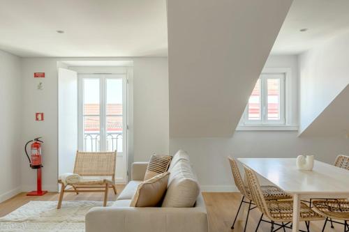 a living room with a couch and a table at Tulum Bohemian 2BR Apartment in Caparica