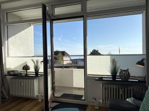 a living room with a view of a balcony at Strandhotel - 19 "Sardinenbüchse" in Dahme