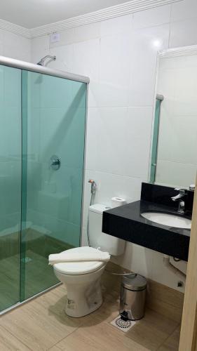 a bathroom with a toilet and a sink at Flat 55 Goiania in Goiânia