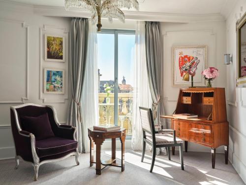 a room with a piano and a chair and a desk at Hotel El Palace Barcelona in Barcelona