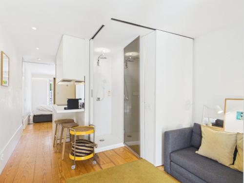 a living room with a couch and a table at Cozy 1BR, Private Terrace & Pool – Estrela | By Airnest in Lisbon