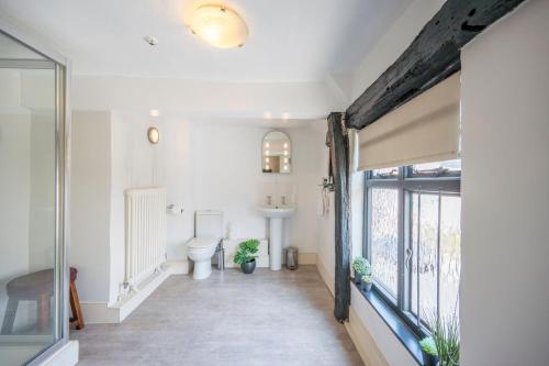 a bathroom with a toilet and a sink at The Merchant House, Ipswich in Ipswich