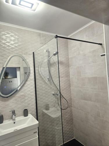 a bathroom with a shower and a sink and a mirror at 2 Mai - RS in 2 Mai