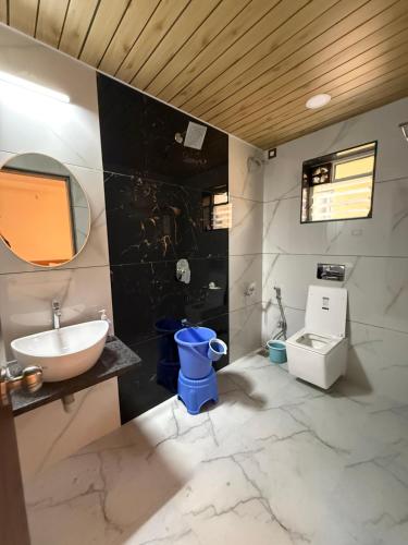 a bathroom with a sink and a toilet at Shreya Bungalow Mahabaleshwar in Mahabaleshwar