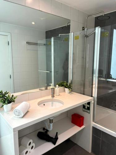 a bathroom with a sink and a shower at MM1 Cosy & Central Apartment in Baixa with Castle View and Free Parking! in Lisbon