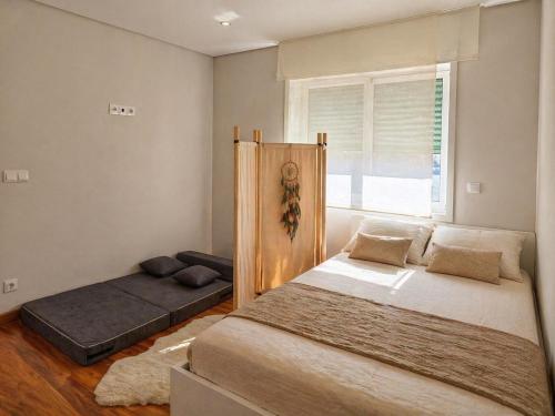 a bedroom with two beds and a window at Vikings AL in Areosa