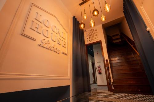 a hallway of a building with a staircase and lights at Local House Lisbon in Lisbon