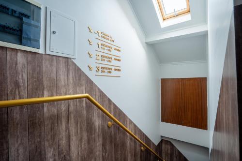 a staircase in a building with a sign on the wall at Local House Lisbon in Lisbon