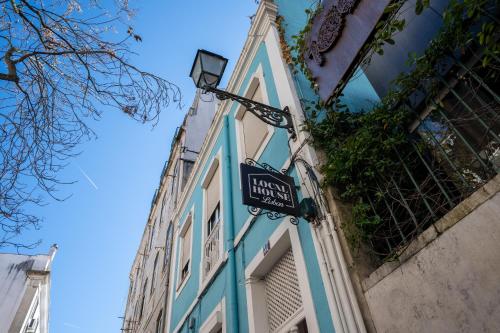a street sign on the side of a building at Local House Lisbon in Lisbon