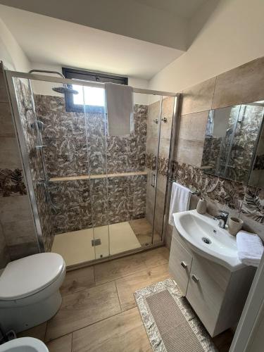 a bathroom with a shower and a toilet and a sink at Soft landing at home in CTA
