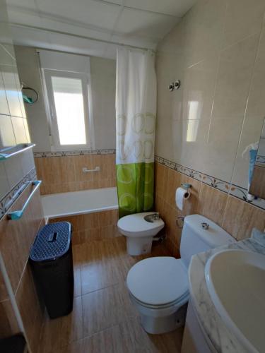 a bathroom with a toilet and a sink and a tub at Sueno de Peniscola in Peniscola