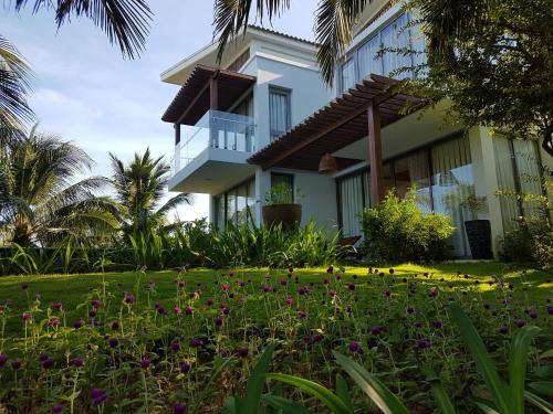 a house with a garden in front of it at Sonata Resort & Spa in Phan Thiet