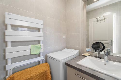 a bathroom with a toilet and a sink at Grand T2 proche plage in Six-Fours-les-Plages