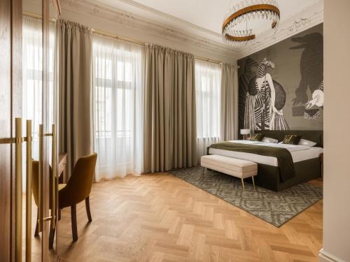 a bedroom with a king sized bed and a chair at Hotel Traugutta 12 in Łódź