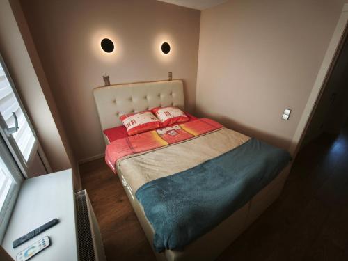 a small bed in a small room with two pillows at Panorama View Suite in Jelgava