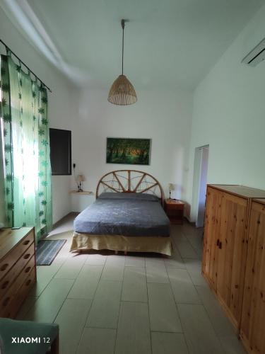 a bedroom with a bed and a television in it at Mambo House in Sarroch