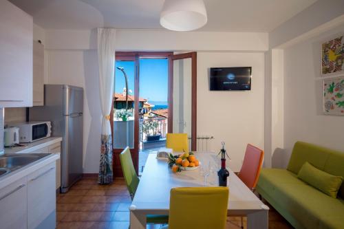 a kitchen and living room with a table and chairs at Taormina Matthome in Taormina
