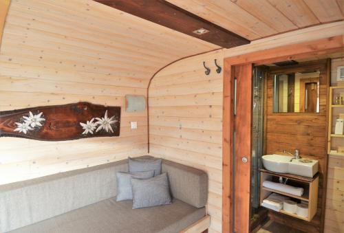 a bathroom with a tub and a sink in a room at Les chambres et Roulottes des Noisetiers in Leysin
