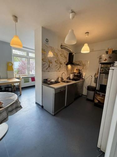 a kitchen with a sink and a stove at Bazylika hostel in Warsaw