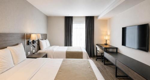 Llit o llits en una habitació de Hotel Nuvo