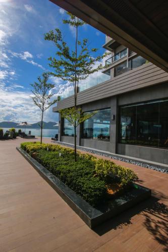 a building with a tree in front of it at Two Seasons Coron Bayside Hotel in Coron