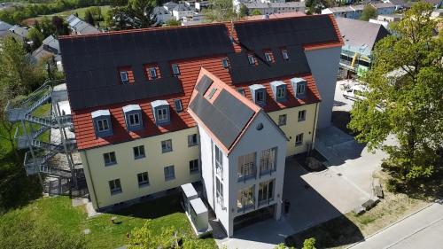 an overhead view of a large house with a red roof at Cityhotel Donauwörth in Donauwörth