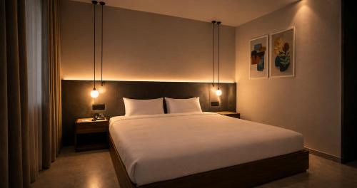 a bedroom with a large white bed with lights on it at Hotel Star Islamabad in Islamabad