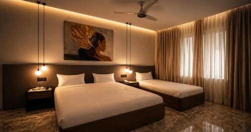 a hotel room with two beds and a painting on the wall at Hotel Star Islamabad in Islamabad