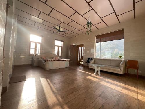 a large living room with a couch and a table at Casa Ramona Luxury Villa With Hot Tub Near Dharamshala Palampur in Pathyar