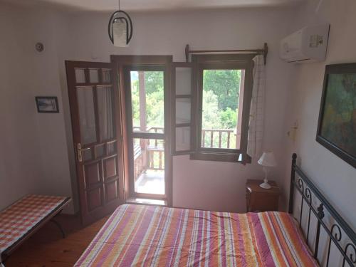 a bedroom with a bed and two windows at Villa İkiz in Ula