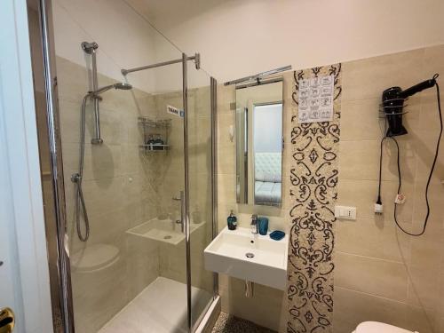 a bathroom with a shower and a sink at B&B Elisir in Albenga
