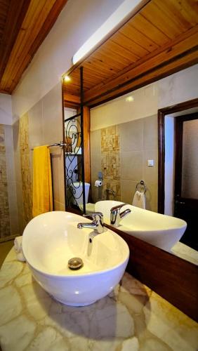 a bathroom with a white sink and a mirror at Soa Refuge in Antananarivo