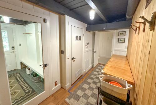 a room with a hallway with a table and a door at Chalet Valhalla wHot Tub in Sugarbush Village