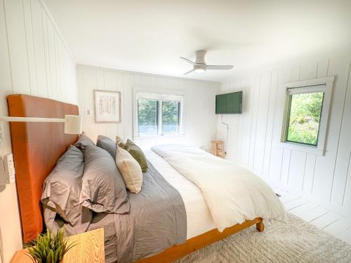 a bedroom with a large bed with pillows at Chalet Valhalla wHot Tub in Sugarbush Village
