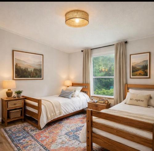a bedroom with two beds and a window at The Firefly Lodge at Shenandoah in Rileyville