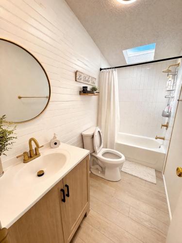 a bathroom with a sink and a toilet and a mirror at The Firefly Lodge at Shenandoah in Rileyville
