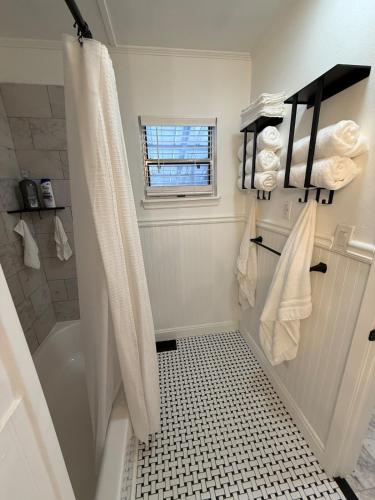 a bathroom with a shower and a bath tub at The Sago Palm House in Thomasville